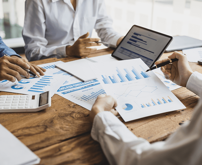 Team analyzing financial charts and data during a meeting.