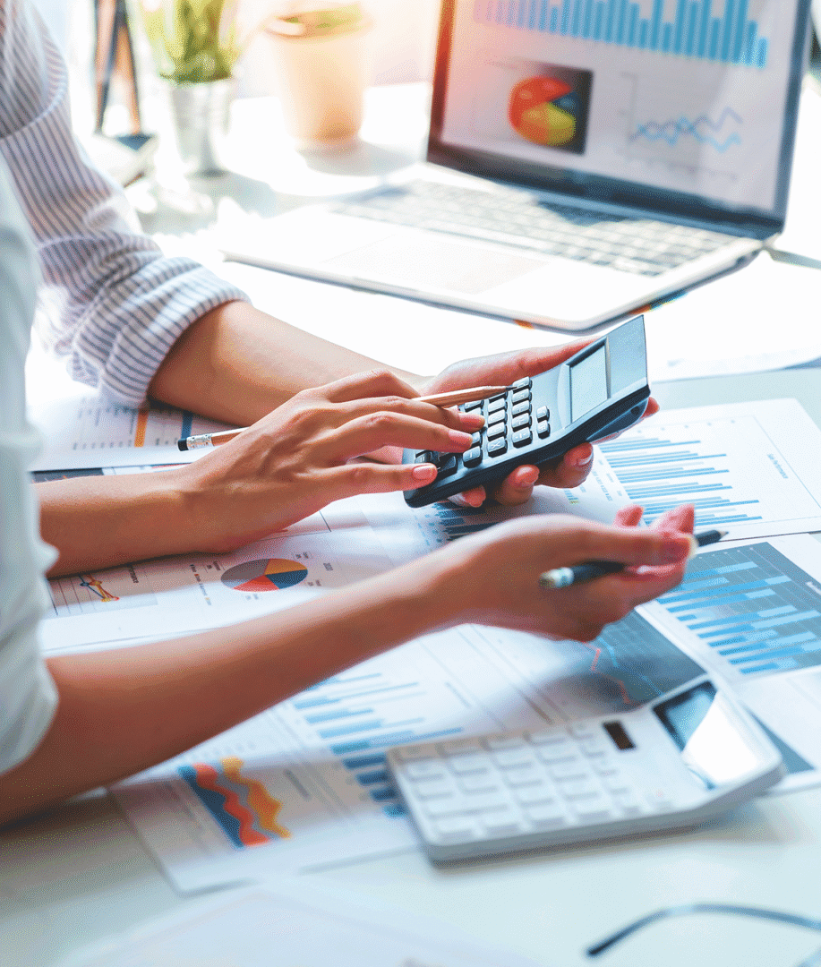 Hands using calculator on financial documents.