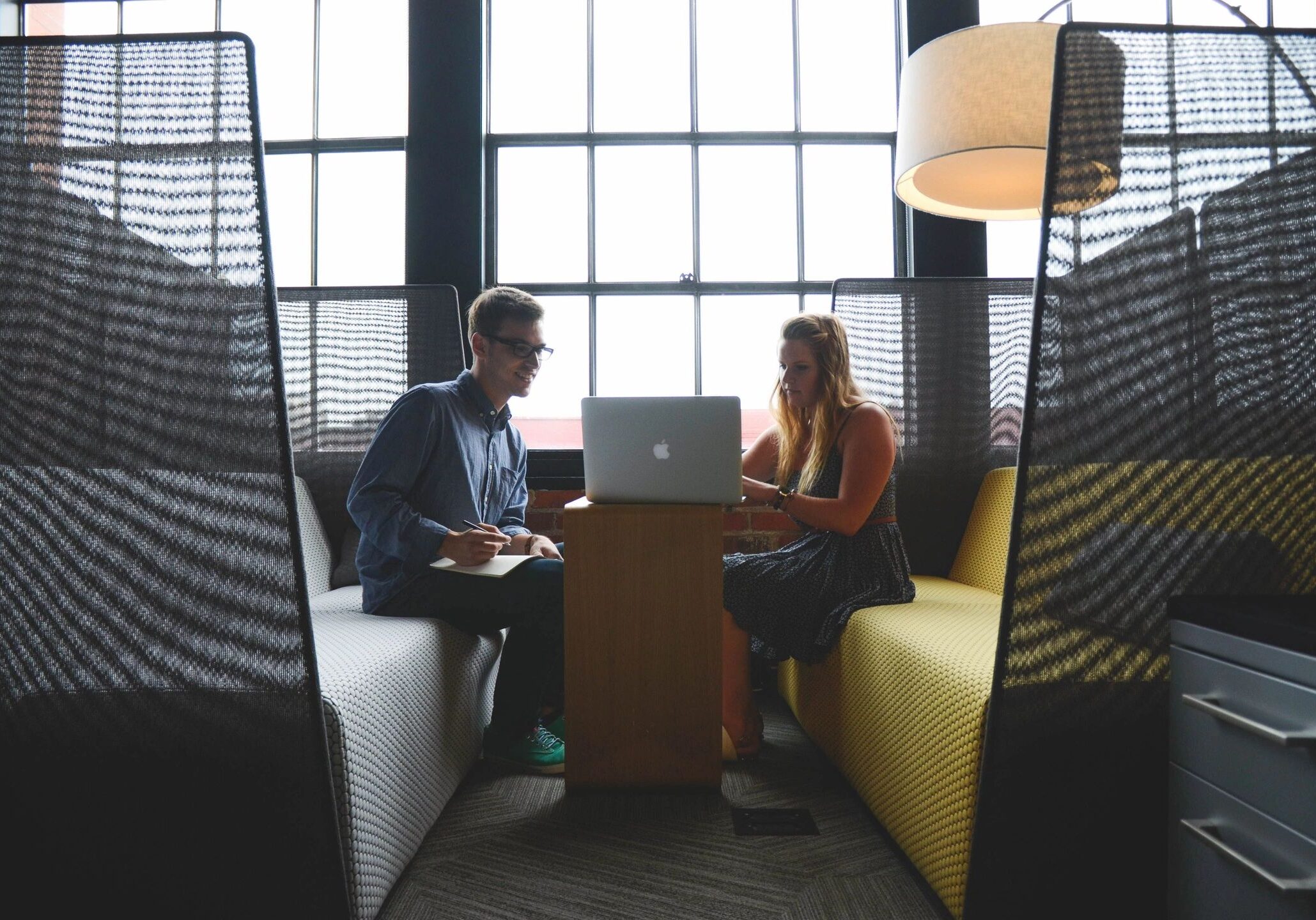 a man and woman working on a laptop
